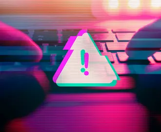 A person types on a keyboard with a malware virus alert