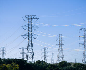 Electrical transmission towers and lines against a blue sky