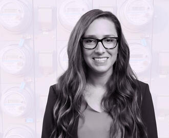 Jacqueline Pless amongst a background of digital electricity meters