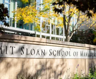Inscription on wall outside of building E62 reading MIT Sloan School of Management