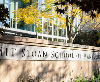 Inscription on wall outside of building E62 reading MIT Sloan School of Management