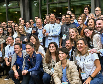 A large group of people poses for a photo off camera