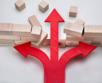 An arrow breaks through a wall of wooden blocks