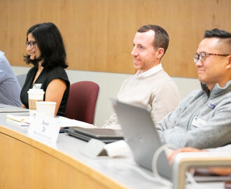 Students sitting in class smiling