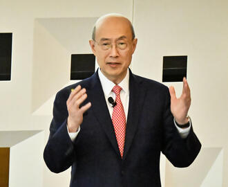 A person delivers a lecture to a crowded auditorium