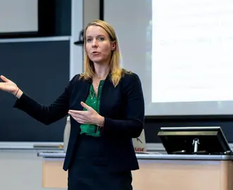 Bethany Patten speaking in a classroom.