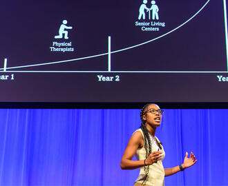 Qadence startup presents on stage at MIT Delta V Demo Day