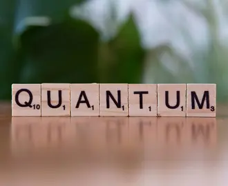 Scrabble pieces spell out the word "Quantum"