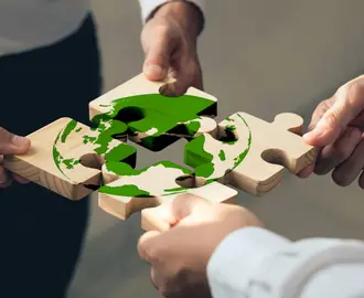 hands assembling climate jigsaw puzzle