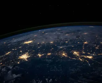 space level view of the earth, lights of major cities visible 