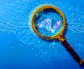A magnifying glass views the letters "AI" and a circuit board