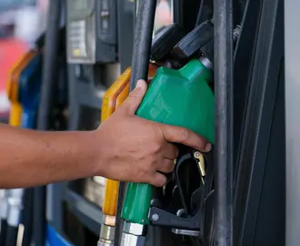 A Person's Hand Holding a Gas Pump