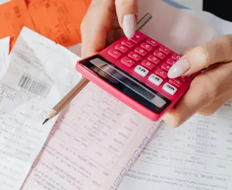 Close-Up Shot of a Person Holding a Calculator