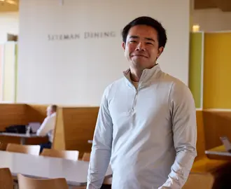 student stands in Sloan cafe