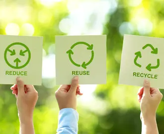 People holding recycling signs