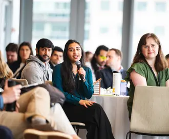 ClimateCAP attendee holding microphone in audience