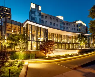 River side of MIT Sloan Building E62 at dusk