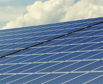 Image of Solar Panels with Clouds in the Background