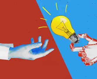 A human hand and a robot hand holding a lightbulb