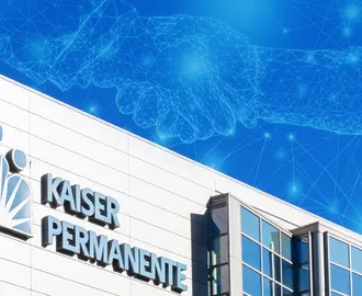 The Kaiser Permanente building with an abstract AI/digital image of a handshake in the sky