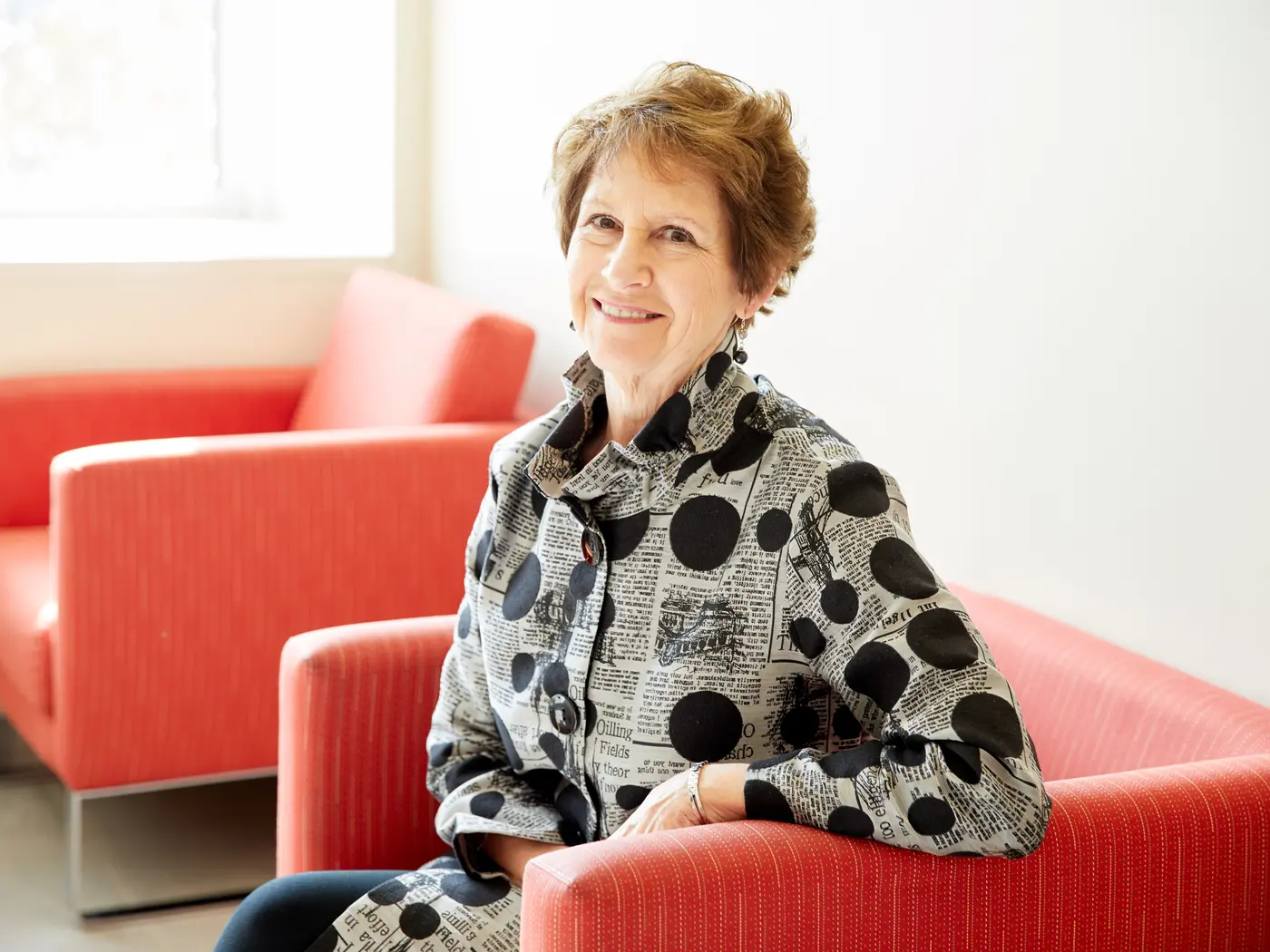 Nancy Van Milligen, CEO and president of the Community Foundation of Greater Dubuque, sitting in red chair