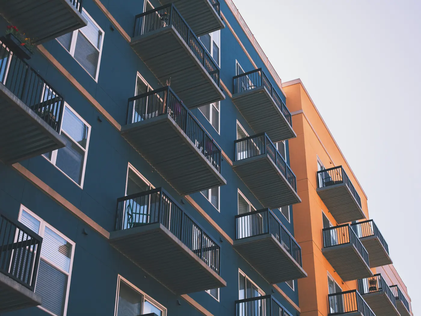 Dark green and orange apartment building with balconies