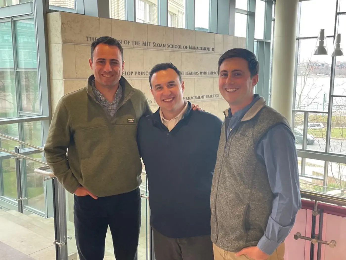 Eric Wainman, Jacob Alchek, and Connor Kozin in the MIT Sloan E62 building
