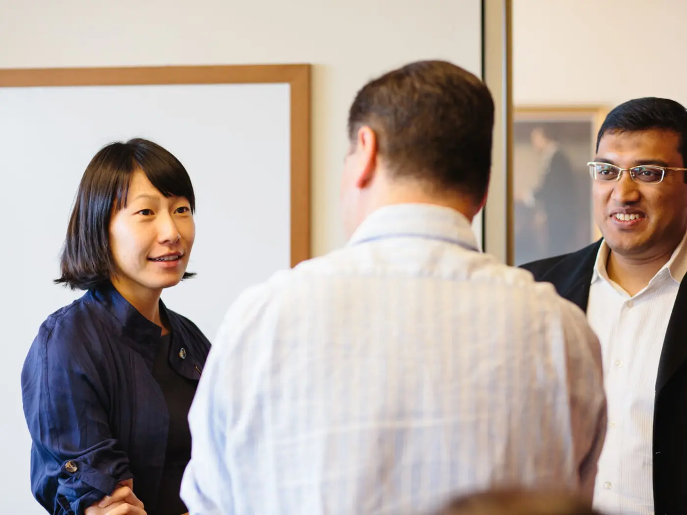 Three MIT students talking in a group