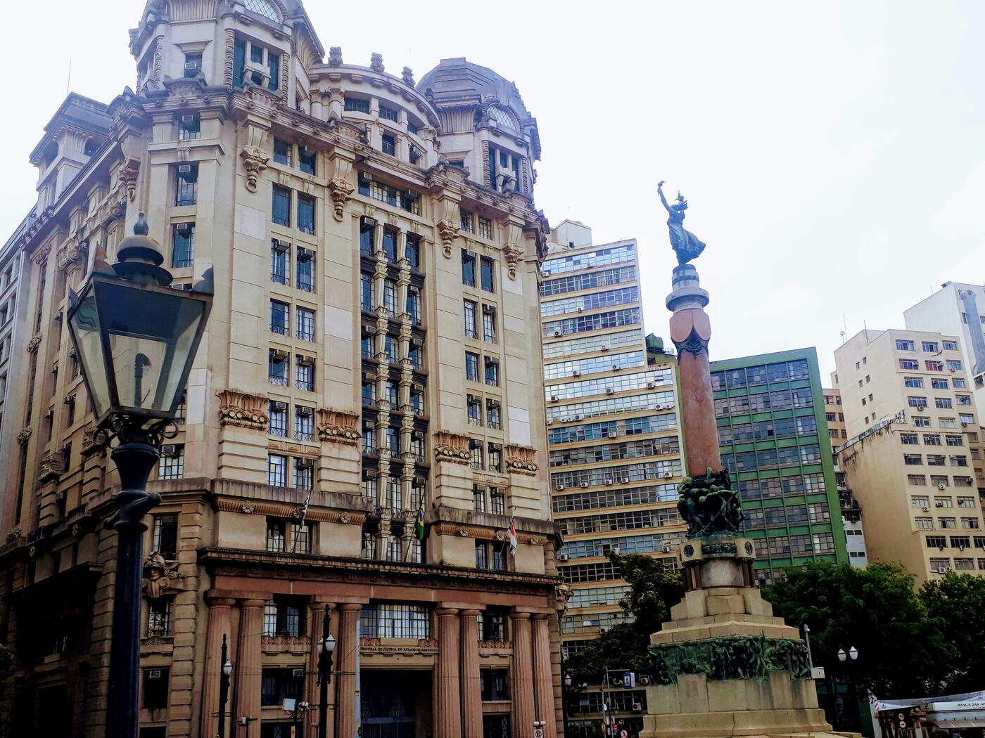 A tall building with a statue in front of it. 