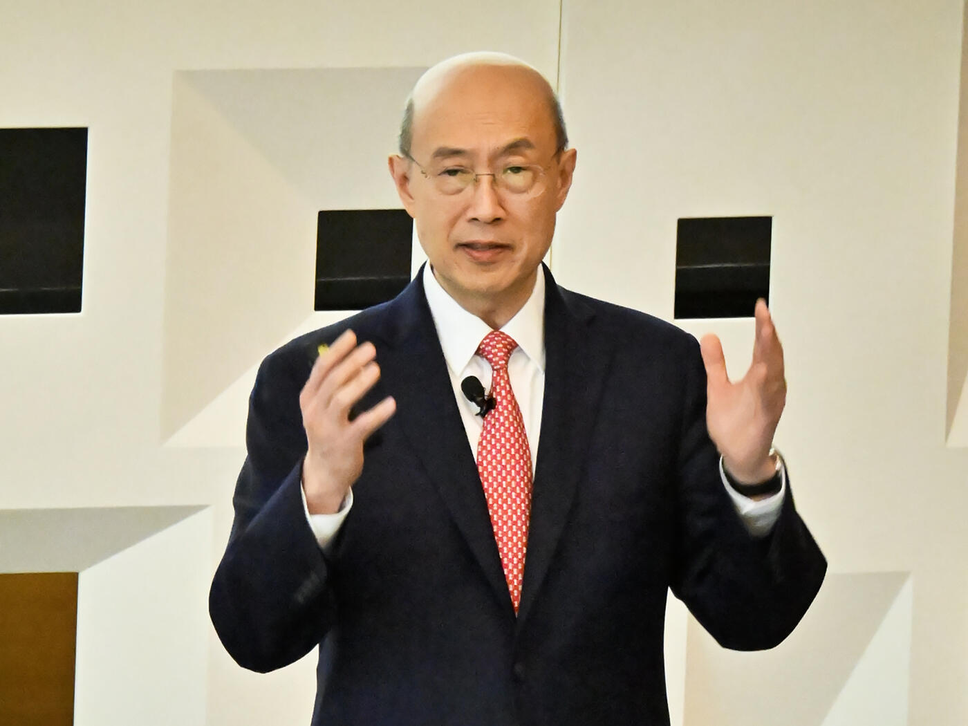 A person delivers a lecture to a crowded auditorium