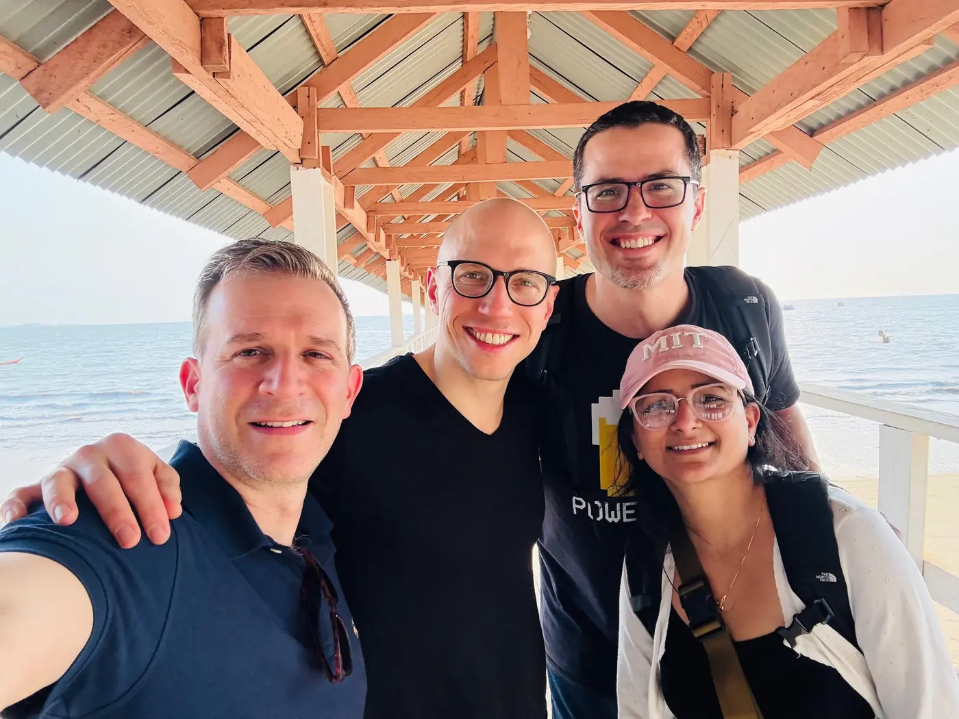 Four GO-Lab students posing under a gazebo near the ocean in Sierra Leone.