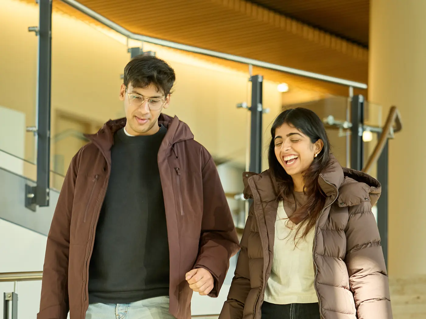 Two people talking while walking down stairs