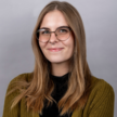 Profressional headshot of woman wearing glasses smiling 