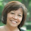 A woman with short brown hair smiling at the camera