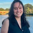 Emily Lemmerman, a doctoral student at MIT Sloan, standing by the Charles River in Cambridge