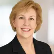 Woman with short blonde hair smiling