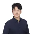 photo of a man wearing a dark shirt against a white background