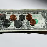 Coins on top of a dollar bill