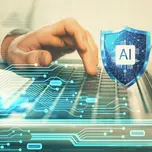 A person types on a computer with an AI cybersecurity shield