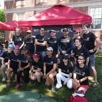 Group of people in matching shirts pose for a photo