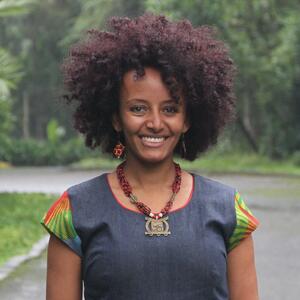 Brukty Tadesse headshot outside in front of grass and trees
