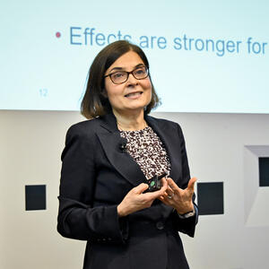 A woman delivers a lecture in an auditorium