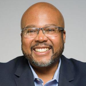 Closeup photo of smiling man in suit jacket