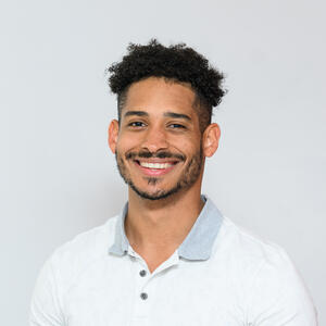 Picture of smiling man wearing white polo shirt