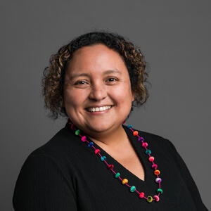 Solangel Fernandez in front of a gray background