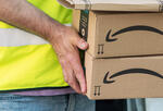 Delivery man holding Amazon boxes
