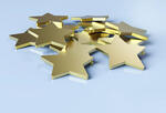 a pile of gold stars on a pale blue background