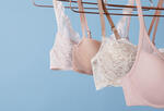 photograph of a series of pastel bras on a light blue background