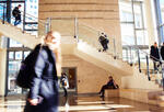 students walk through lobby with staircase