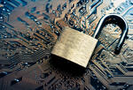 An unlocked padblock over a circuit board
